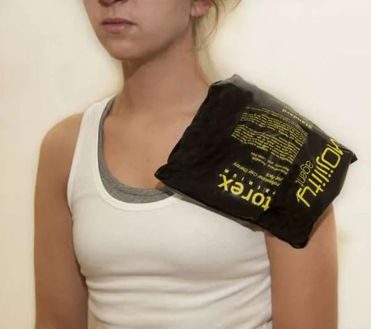 Person using a black Torex shoulder wrap on a plain background