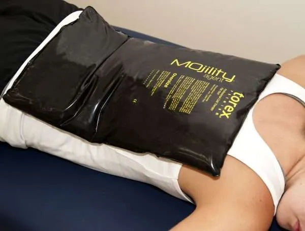 Oversize - Person using a black ice pack labeled 'Mojillity' on their back.