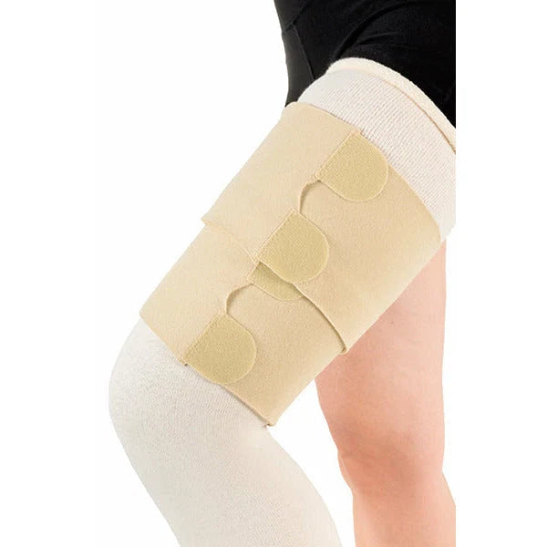 Beige knee brace on a person's knee with a white background